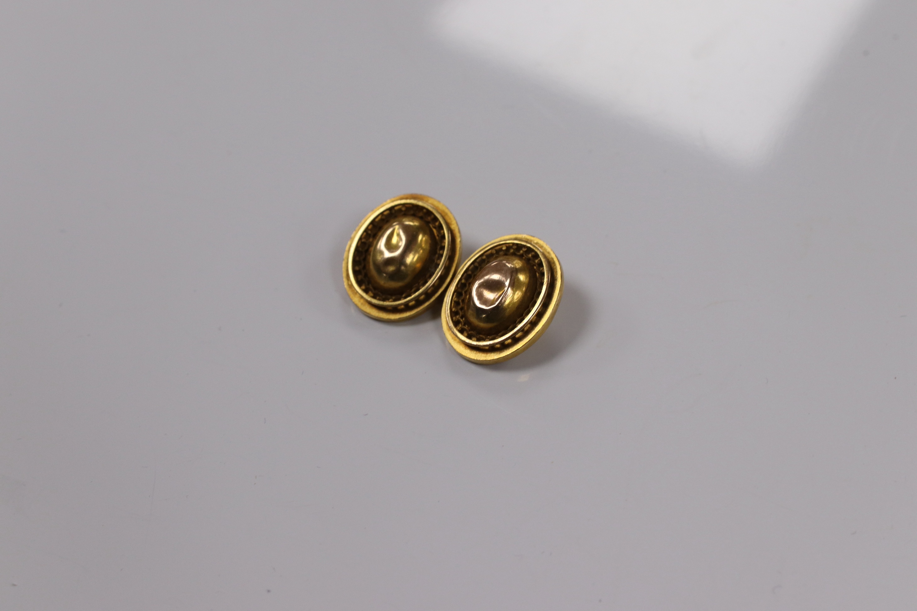 A pair of yellow metal oval cufflinks and three similar dress studs, one stamped 18, gross weight 10.8 grams. Condition - poor